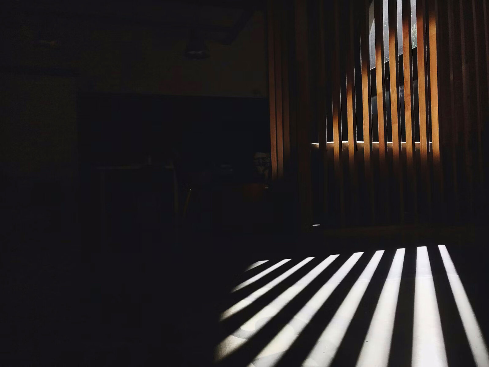 Light filtering through wooden louvres — the upstream triage metaphor